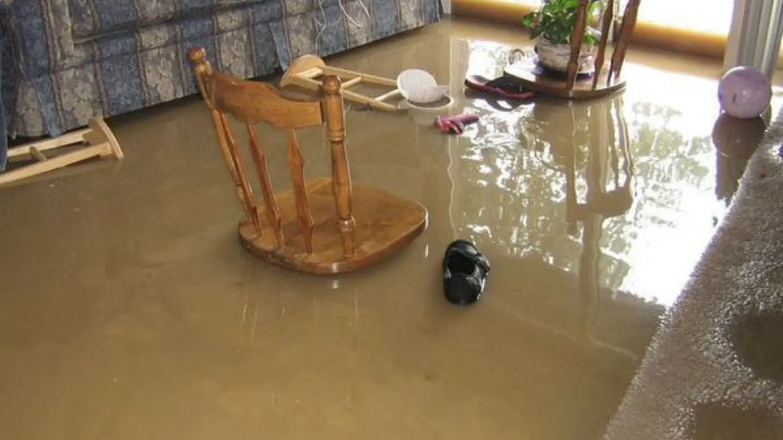 Flooded room with a chair sitting in standing water