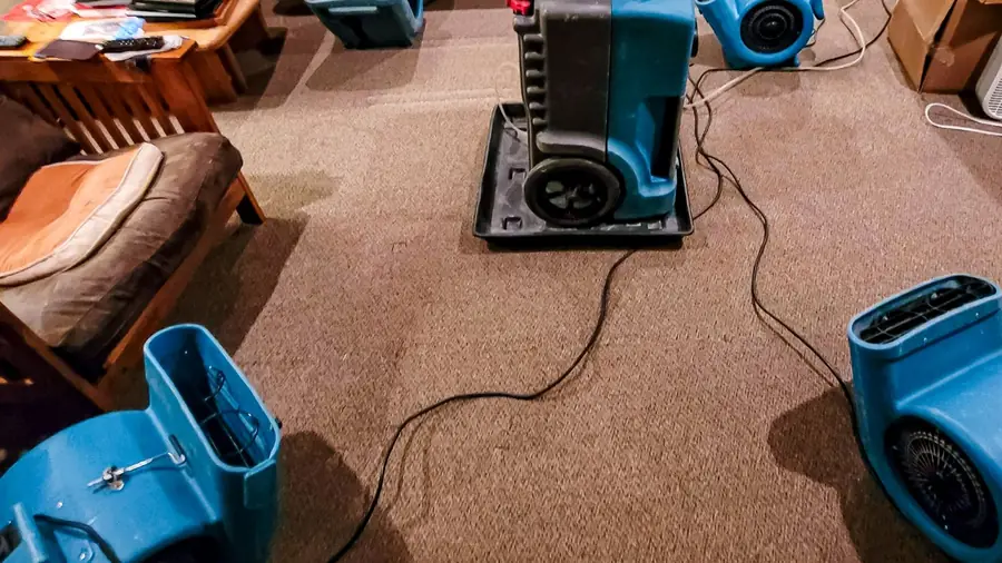 Air movers running on wet carpet